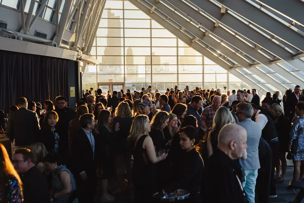 Packed reception under a glass ceiling during Alma Academy