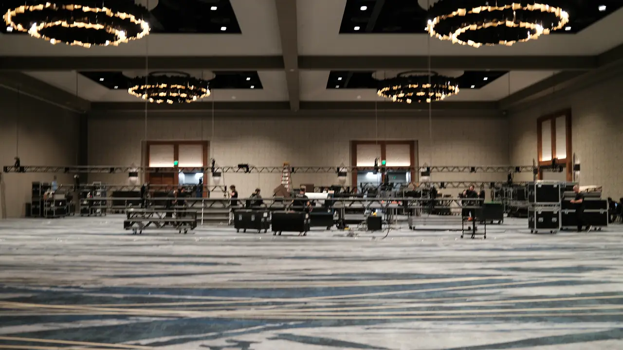 The ballroom at load-in: truss and road cases on an empty floor