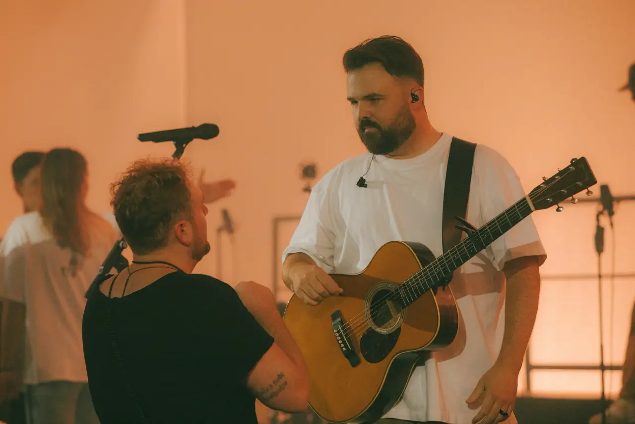 Acoustic guitarist and singer at the microphone during the recording