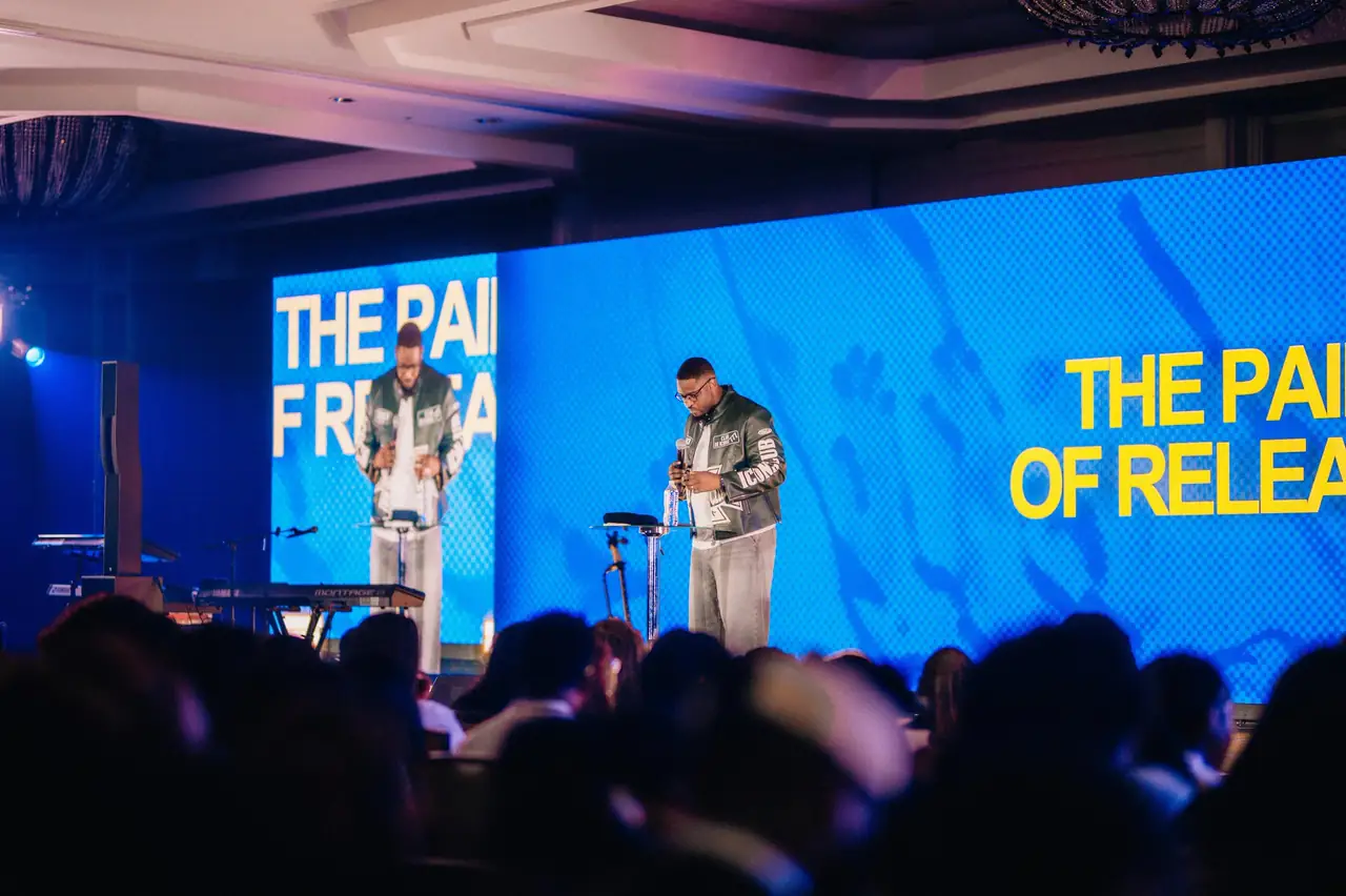 Ballroom transformed with LED walls and stage lighting as attendees dance during worship