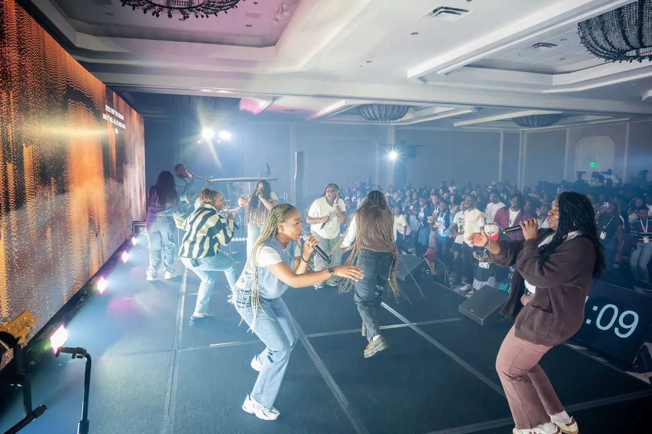 Ballroom transformed with LED walls and stage lighting as attendees dance during worship