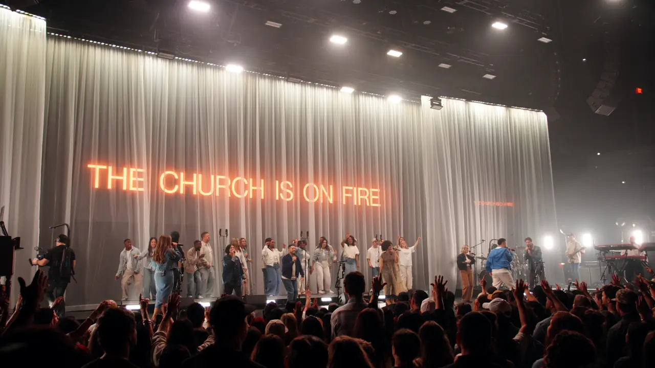 THE CHURCH IS ON FIRE in red letters reading through the drape above the choir at ACL Live