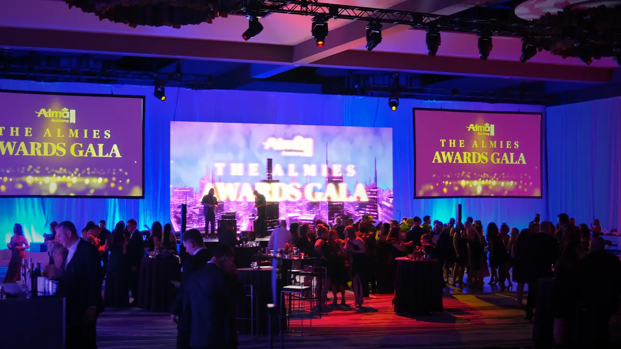 Show night in the same ballroom: The Almies Awards Gala on the LED wall and side screens, guests on the floor