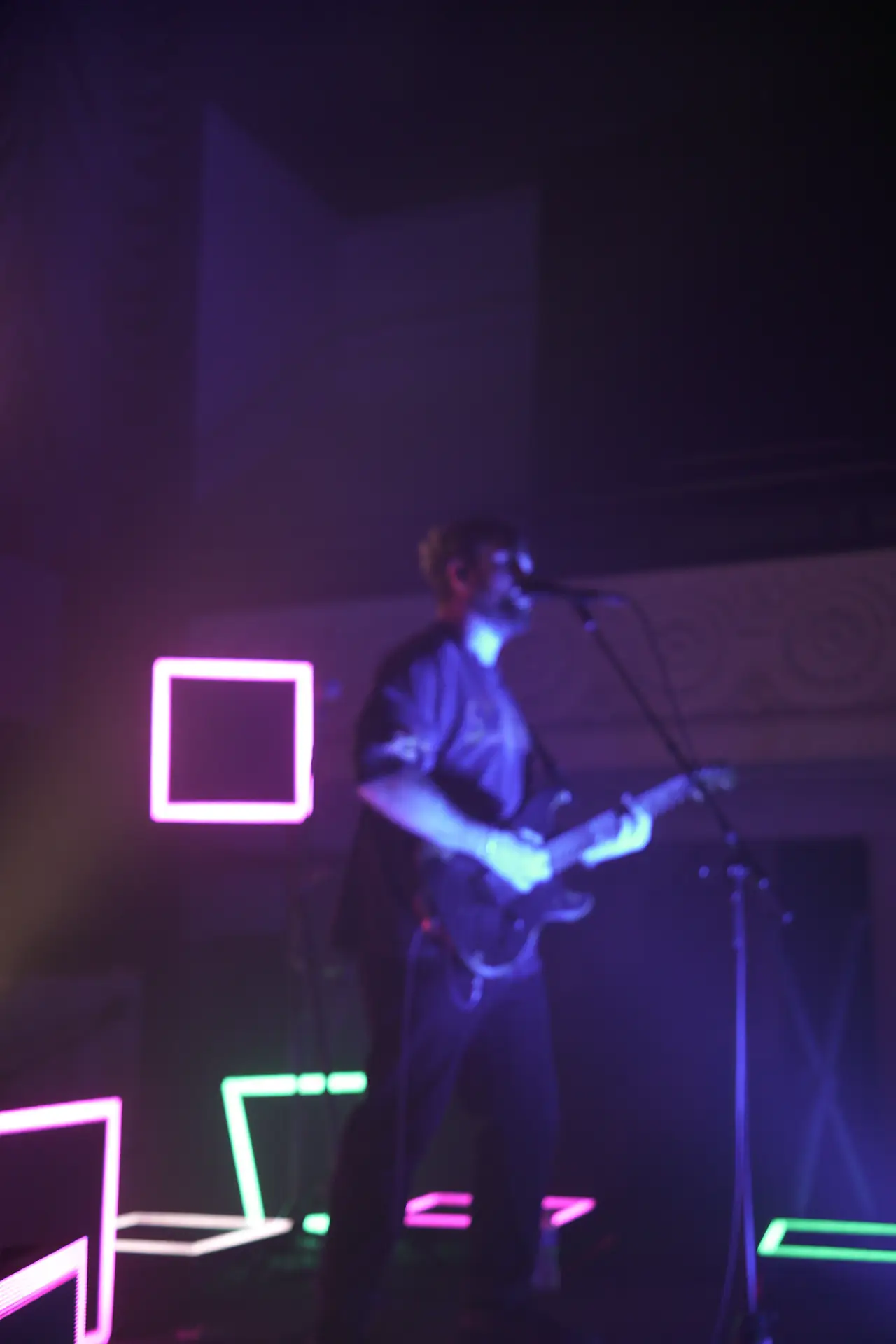 Stephen Stanley in purple light, framed by an outlined square on the LED