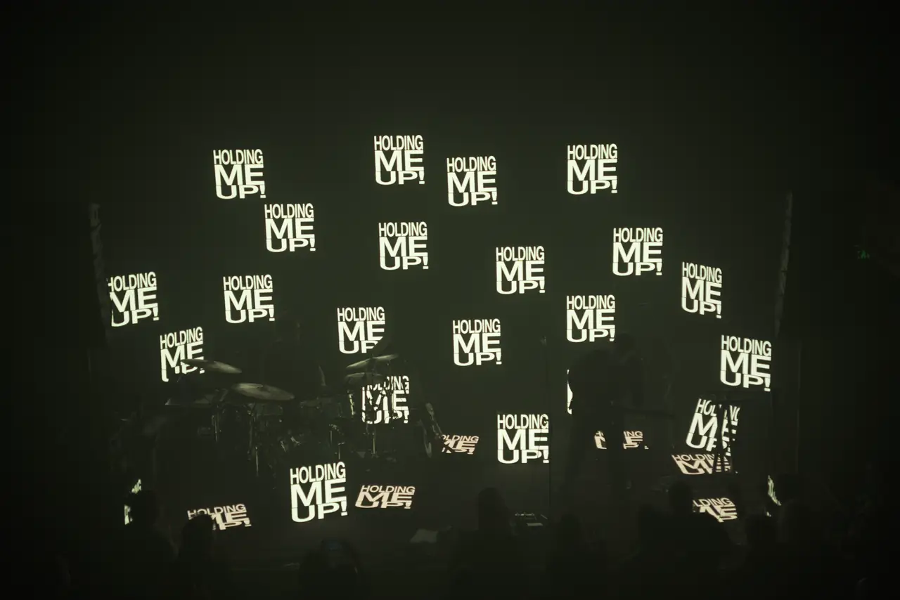 Stephen Stanley on stage in front of a scattered field of LED panels